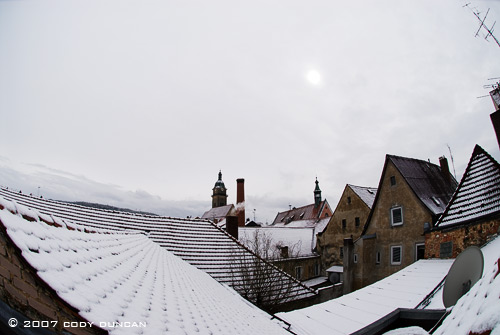 Snow covered rooftops and cloudy skies in small german town. Cody Duncan Photography