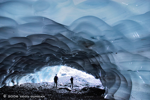 © cody duncan photography.  person in glacier ice cave, Bernese alps, Switzerland