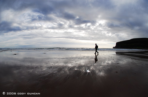 © Cody Duncan Photography.  silhouette of person walking on beach at Rackwick bay, Hoy, Orkney, Scotland