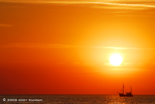 Fishing boat in North sea at sunset, Juist, Germany.  © Cody Duncan Photography