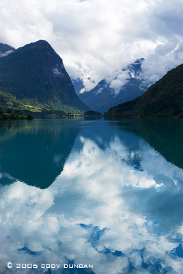 Scenic mountain reflection in lake, Norway. © Cody Duncan Photography