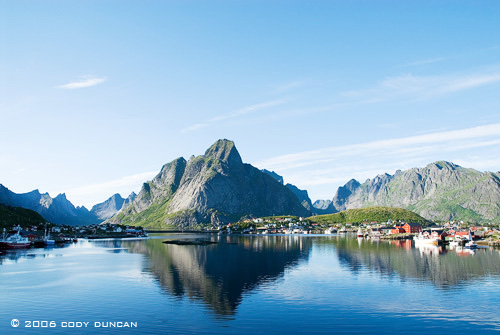 reflection of mountains and village of Reine in lofoten Islands, Norway.  © Cody Duncan Photography