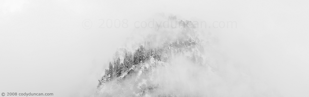Cody Duncan Stock Photography: Panoramic landscape photo of Snow covered mountain and clearing clouds. © Cody Duncan Photography