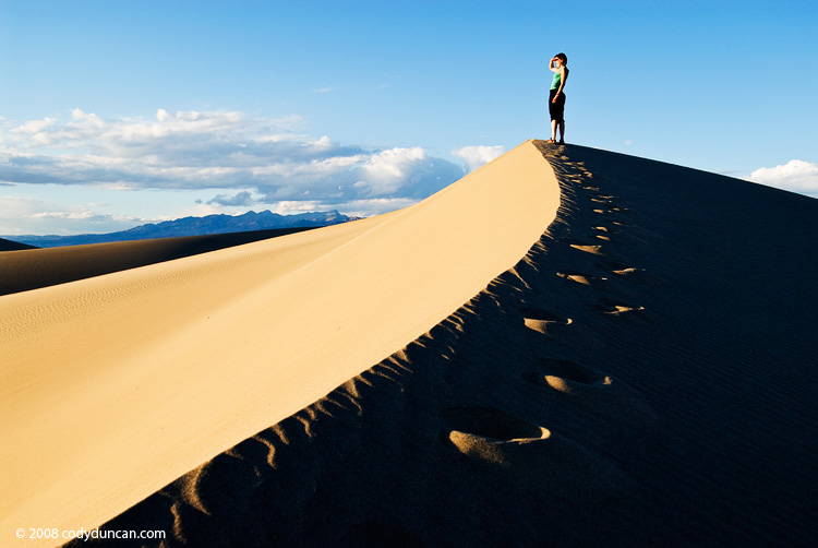 Female walking along sand dune, Death Valley national park, California