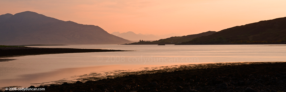 Panoramic stock photo: Evening light on Loch Duich with mountains of Isle of Skye in far distance, Scotland. Cody Duncan Photography