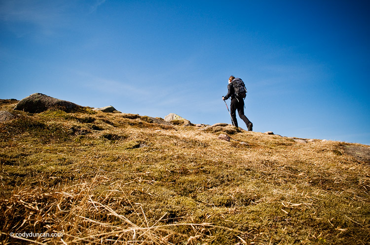 travel lifestyle stock image: Female hiker in alpine terrain of Cairngorm mountains, Scotland