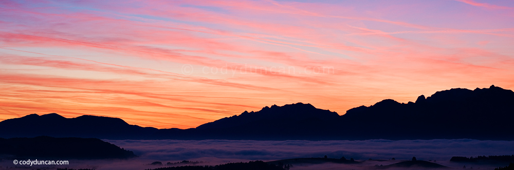 Germany panoramic stock photo: Sunrise over Allgaeu alps with valley fog, near Fuessen, Bavaria, Germany