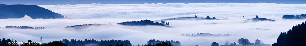 Germany panoramic stock photo: hills rise above morning fog, Allgaeu region, Bavaria, Germany