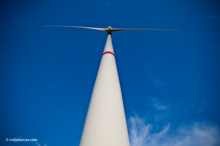 Alternative green energy production stock photo: Power generating wind turbines stand in farm field, Bavaria, Germany. Cody Duncan photography