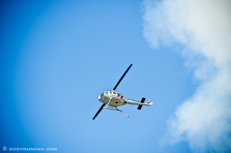 Fire fighting helicopter flying in sky above santa barbara, CA