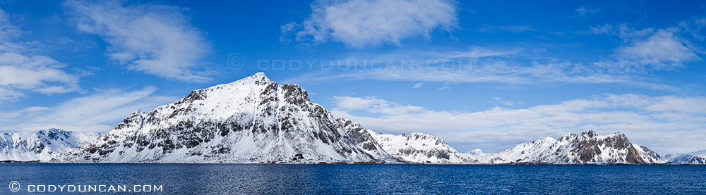 Justadtind and mountains of Vestvagoy rise from sea fjord, viewed from near Stamsund, Lofoten islands, Norway