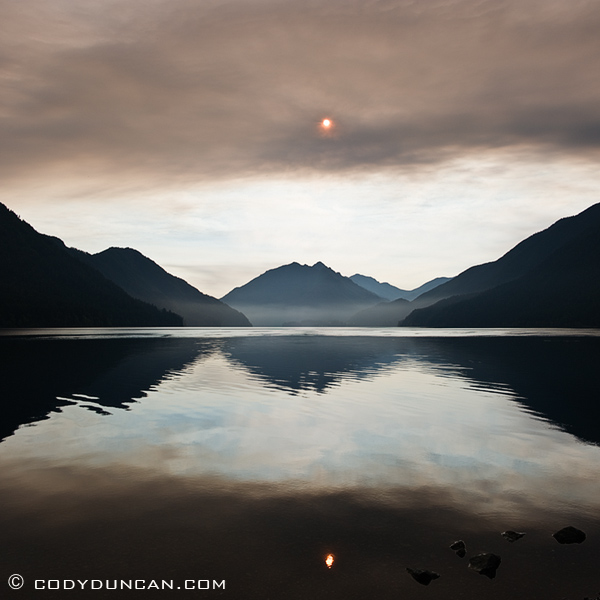 Landscape travel stock photography: Smoke from wildfire covers sun over lake Crescent, Washington