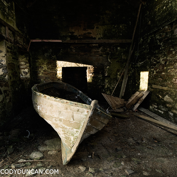Orkney travel stock photograph - Old boat sits abandoned in Barn, South Ronaldsay, Orkney