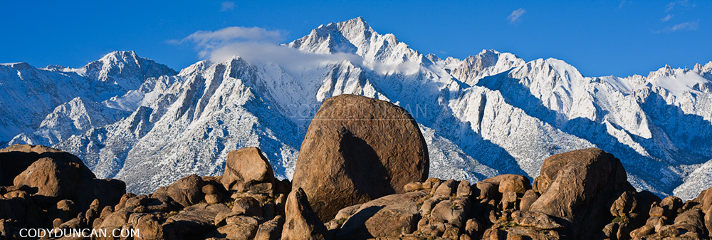 Granite rock formations of Alabama Hills with Lone Pine peak and Sierra Nevada mountains in background, California