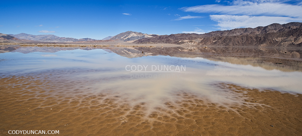 rare winter water fill dry lakebed of devils racetrack playa - death valley, california