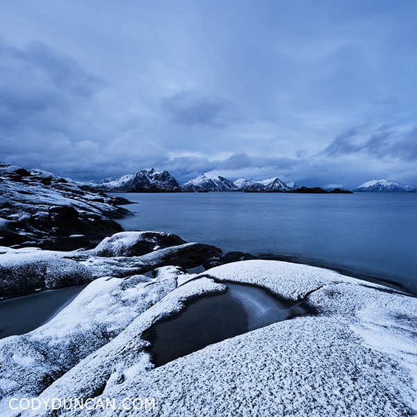 Travel stock photo: Snow covered rocky coastline at Stamsund, Vestvågøy, Lofoten islands, Norway