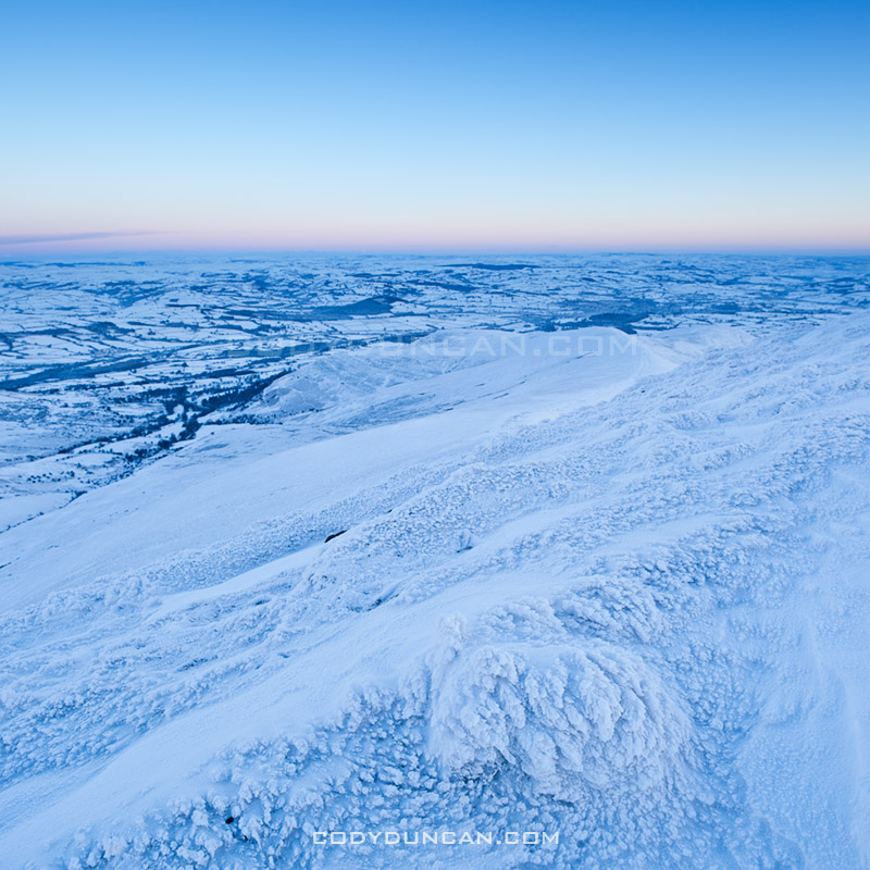 Winter view from Pen Y Fan over a frozen Welsh Landscape, Brecon Beacons national park, Wales