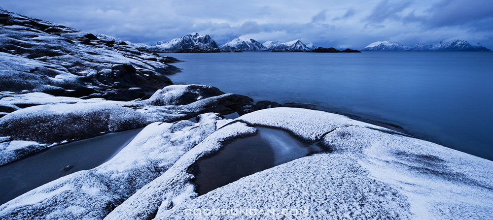 Snow covered rocky coastline at Stamsund, Vestvagoy, Lofoten islands, Norway