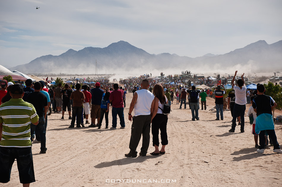 Spectators await arrival of 1st trophy truck at finish of 2011 San Felipe Baja 250