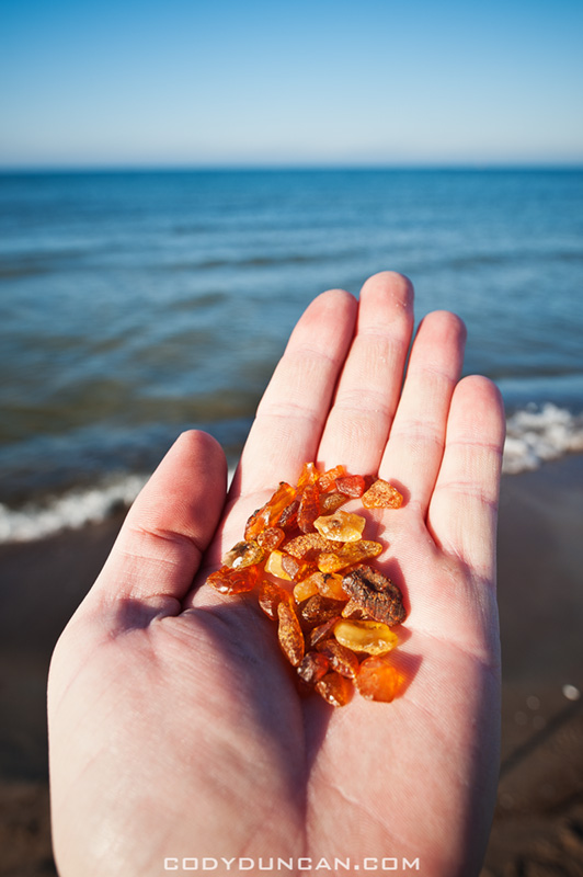 Hand holding amber found on beach