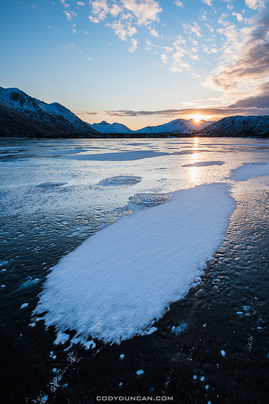 Winter sunrise on frozen lake Urvatnet, Lofoten Islands, Norway