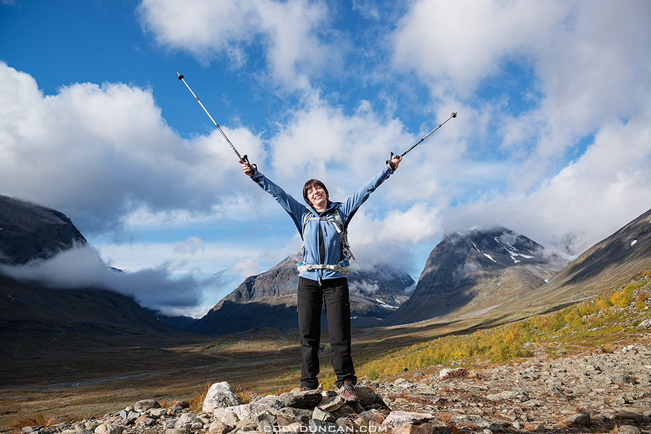 Female hiker with mountains in distance, Ladtjovagge, near Kebnekaise Fjällstation, Lappland, Sweden