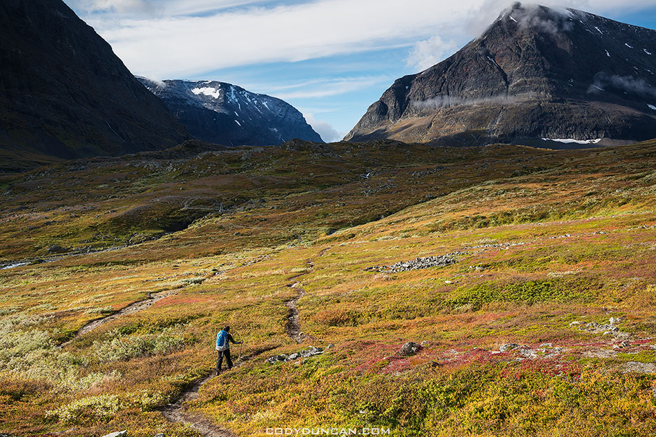 Hiking trail in Ladtjovagge with Tolpagorni - Duolbagorni mountain in distance, Lappland, Sweden